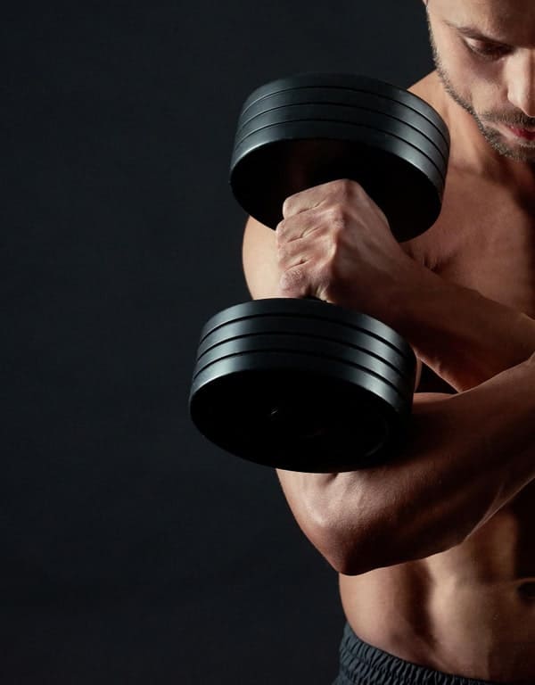 cropped photo athletic man keeping dumbbells min PowerMuscle